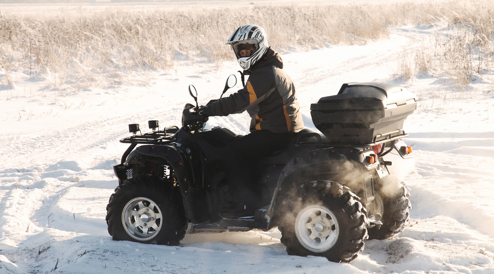 Une personne qui fait du quad en hiver